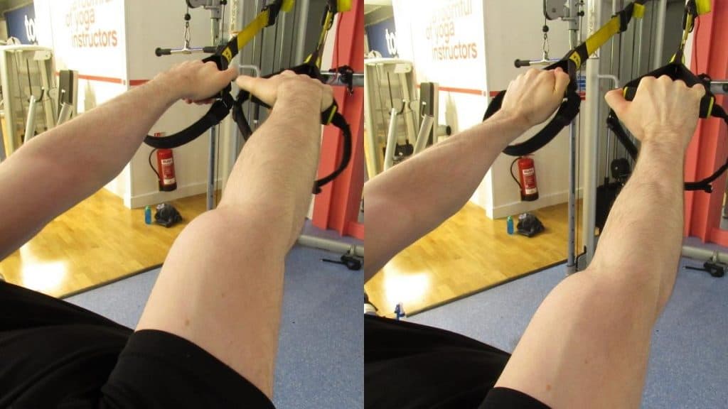 A man performing a TRX forearm workout at the gym