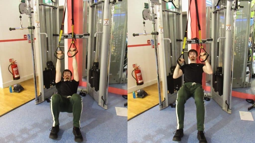 A man doing TRX pull-up holds
