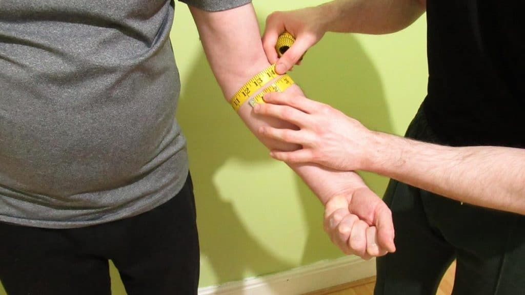A man showing where to measure your forearm circumference