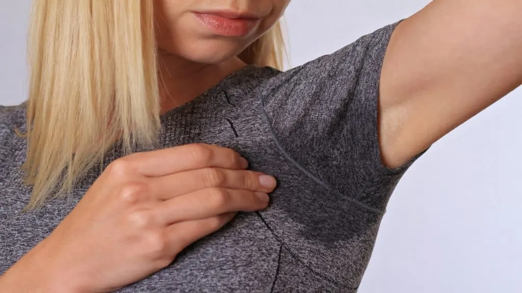 A woman with a sweaty arm pit