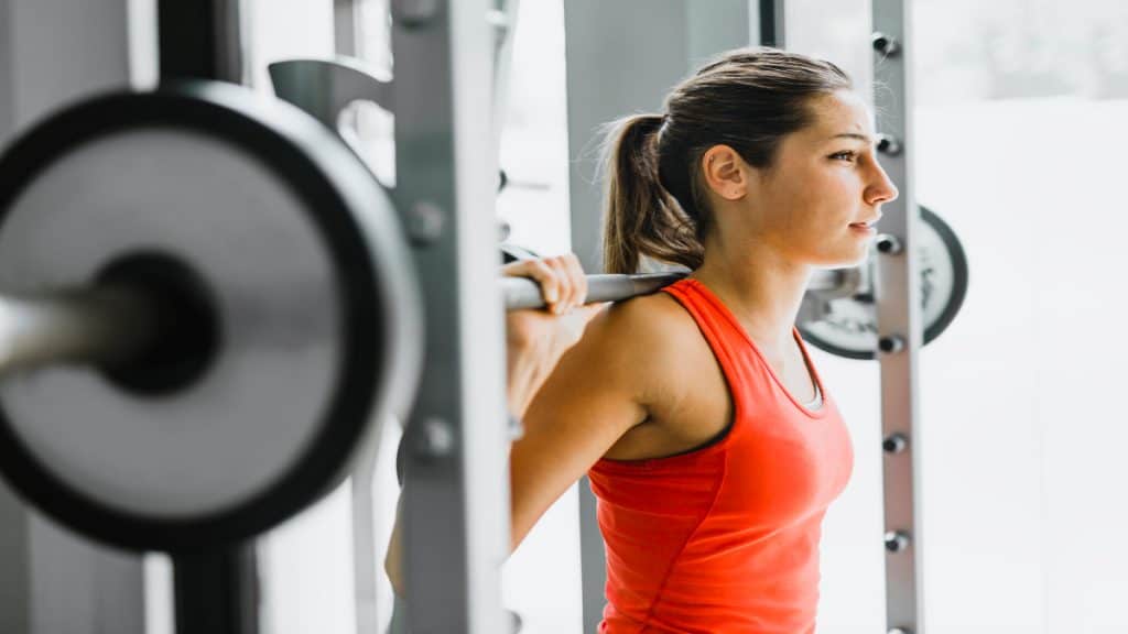 A woman lifting weights in the gym