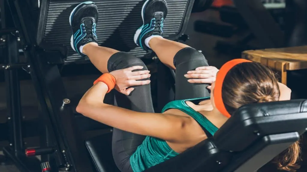 A woman working her legs at the gym