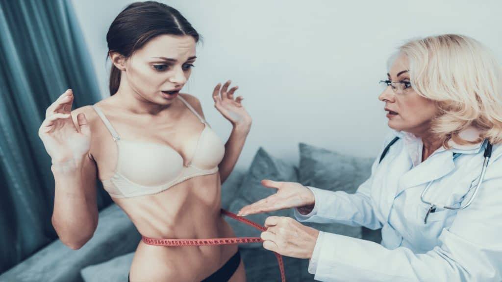 A woman getting her 19 in waist measured