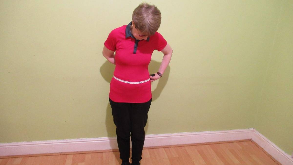 A woman measuring her 30 inch waist