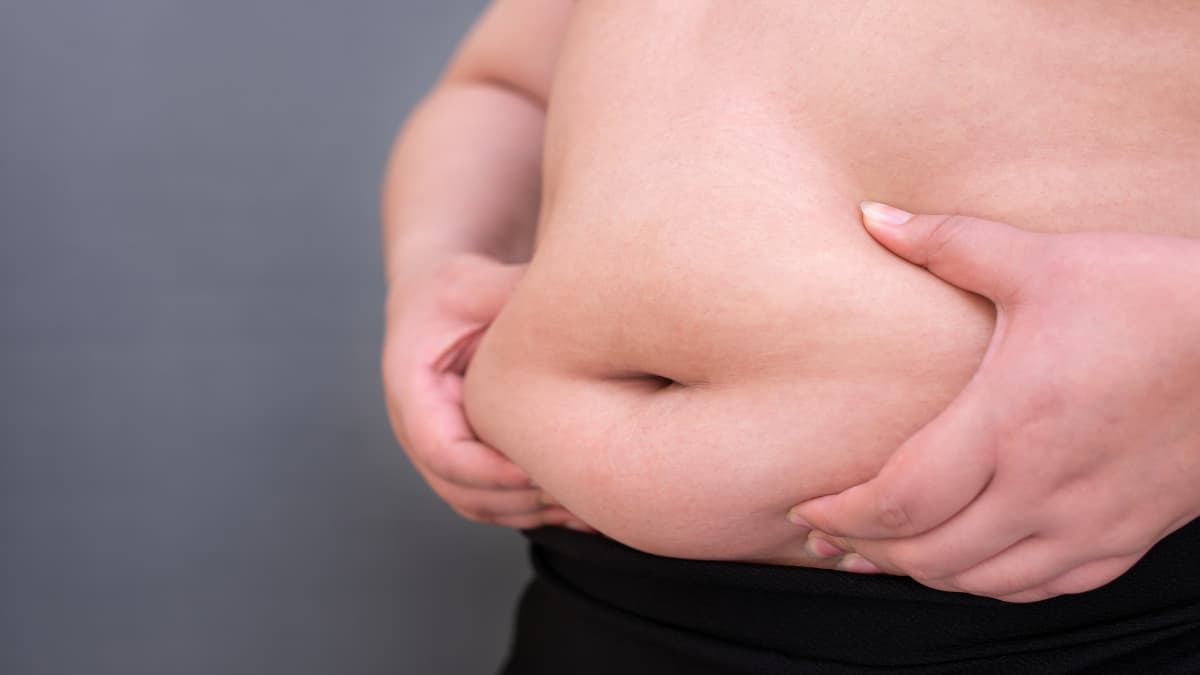 A fat woman grabbing her 41 inch waist