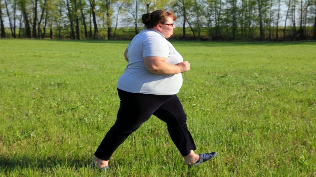 A woman with a 49 inch waistline walking in the park