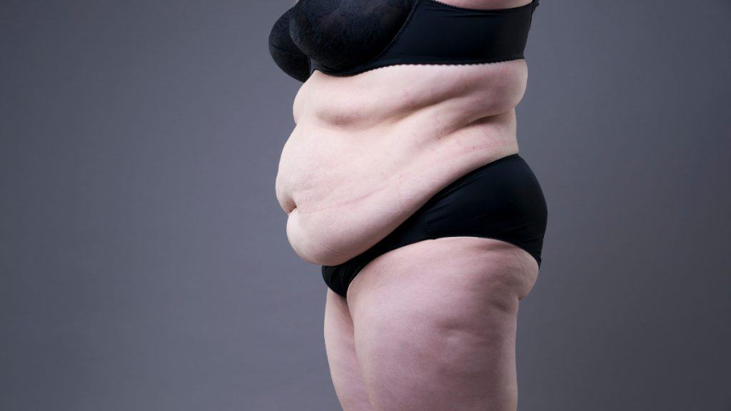 A woman showing her big 55 inch belly