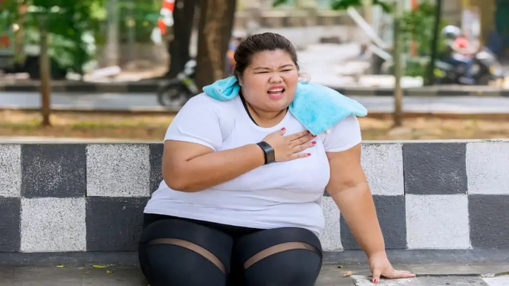 A woman with a 72 in waist with her hand on her chest