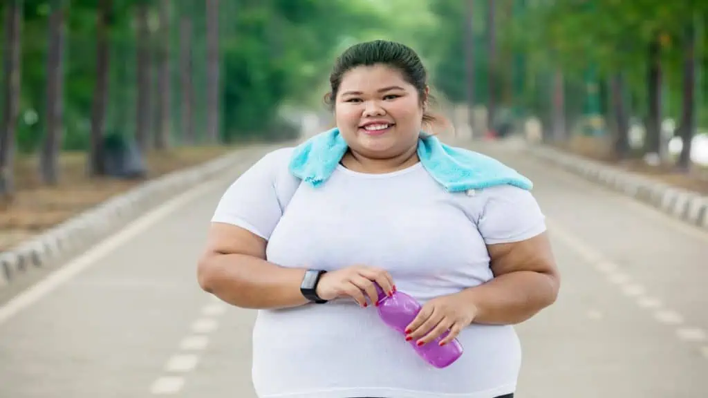 A happy woman with a 72 inch waist after her exercise