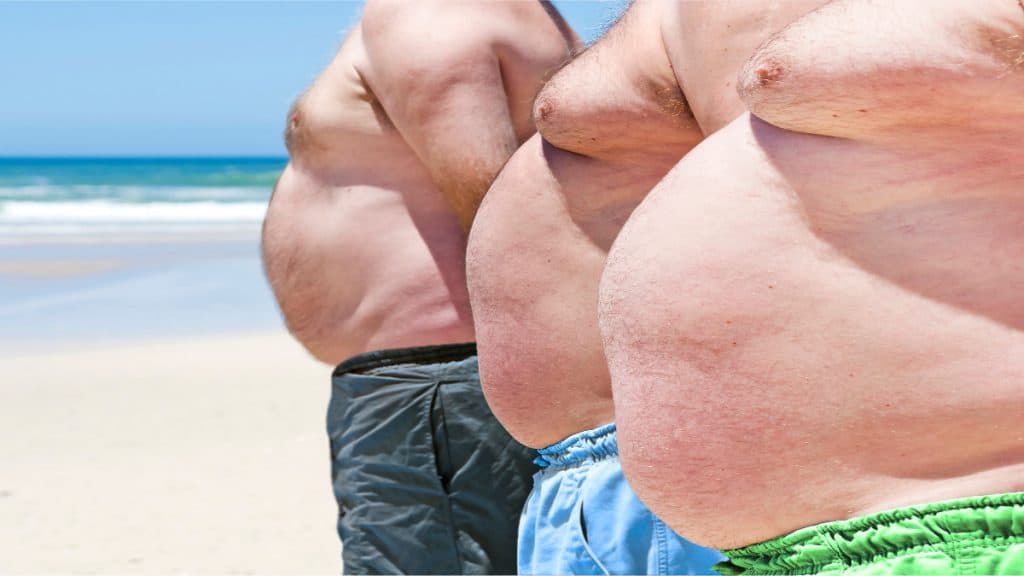 Three fat men with 77 inch waists at the beach