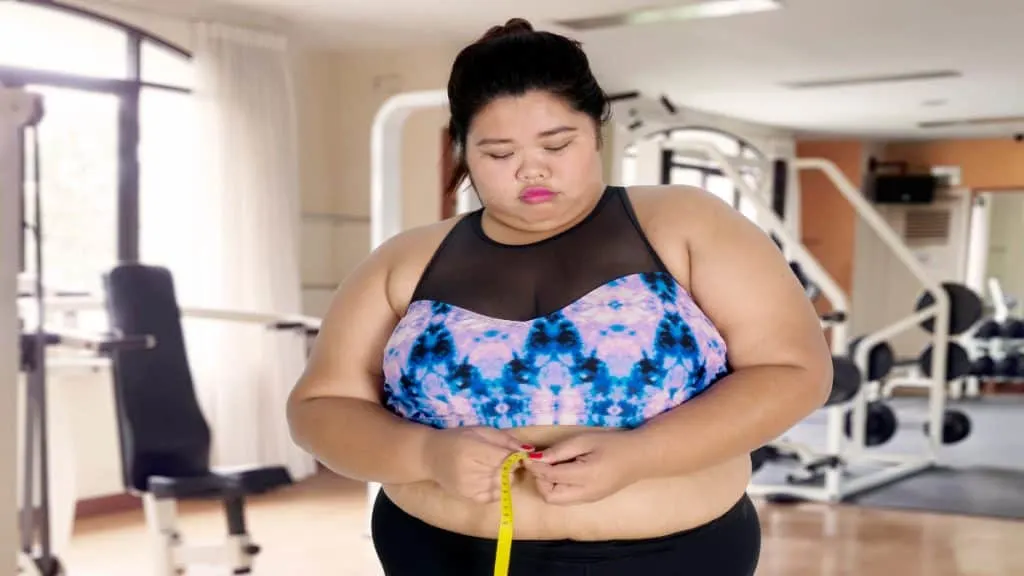 An obese woman measuring her 95 inch waist