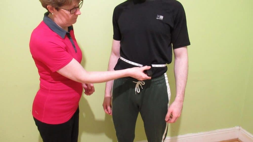 A man showing the normal waist size for a male