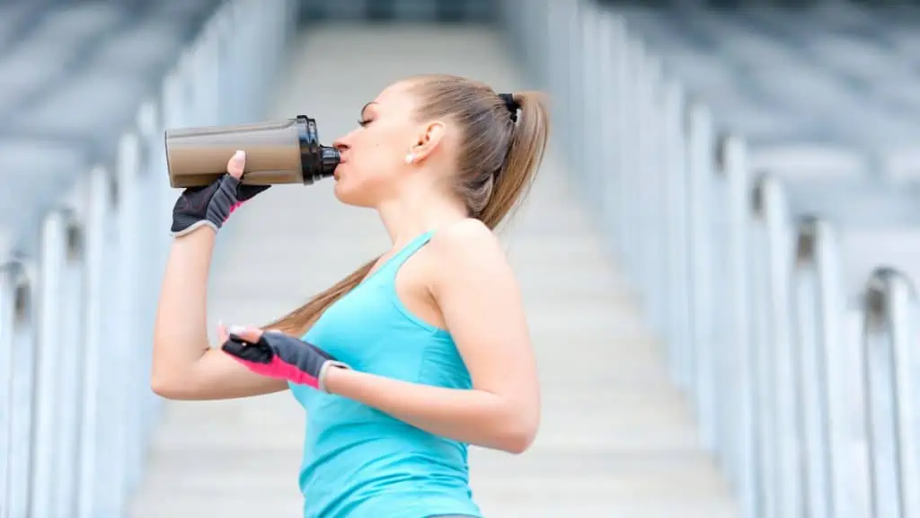 A woman drinking a protein shake