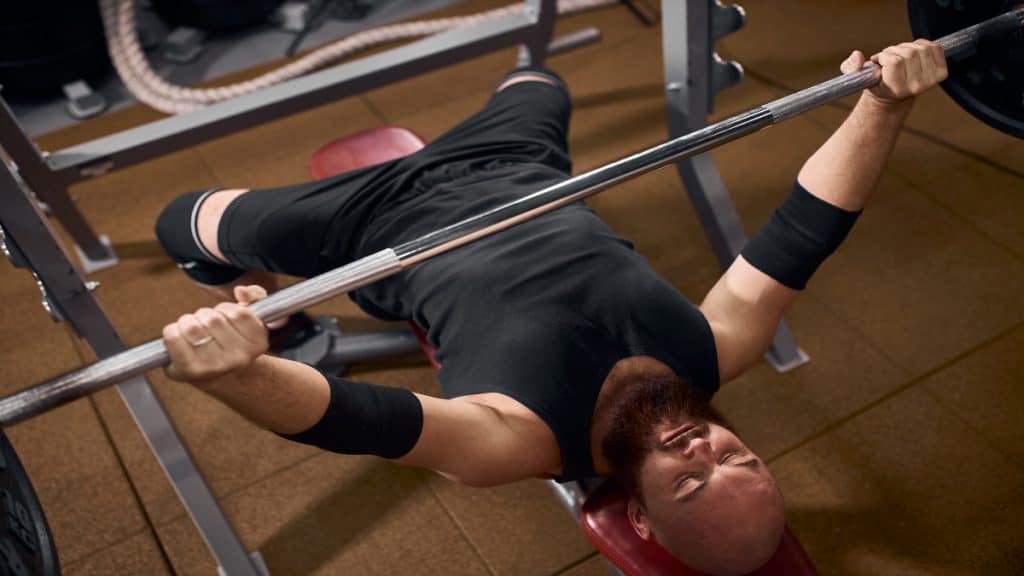 A powerlifter, who is call tricep no bicep, doing a bench press