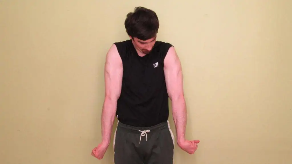 A man showing his flexed tricep muscles