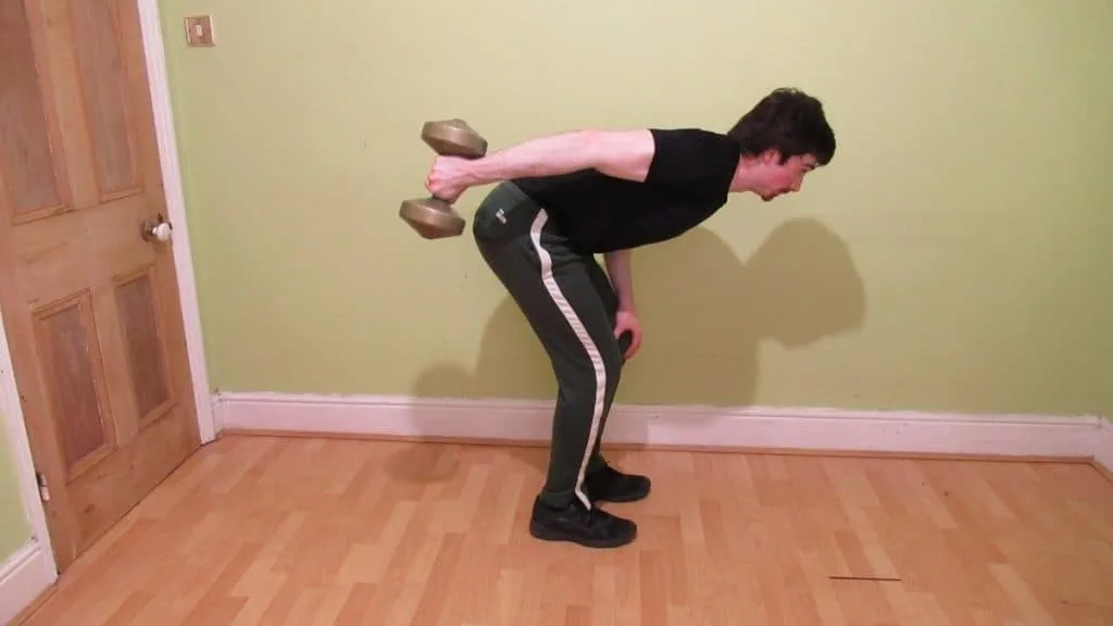 A man performing an isometric tricep kickback