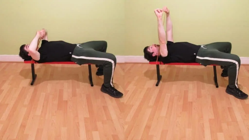 A man doing a resistance band Tate press