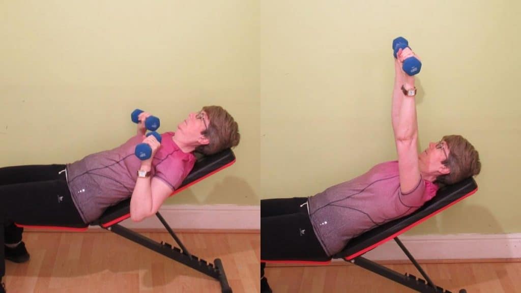 A woman doing an incline dumbbell press