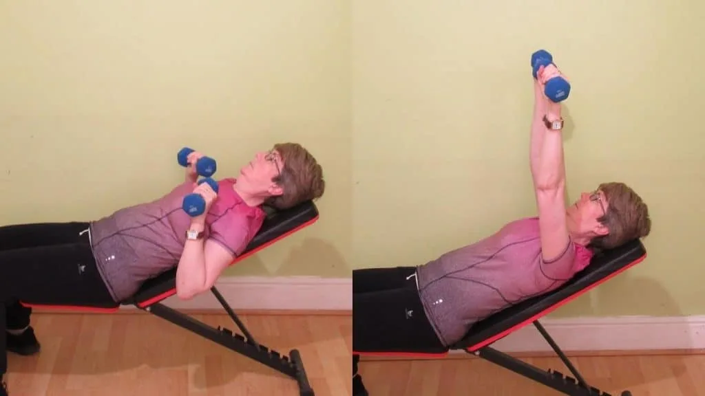 A woman doing an incline dumbbell press