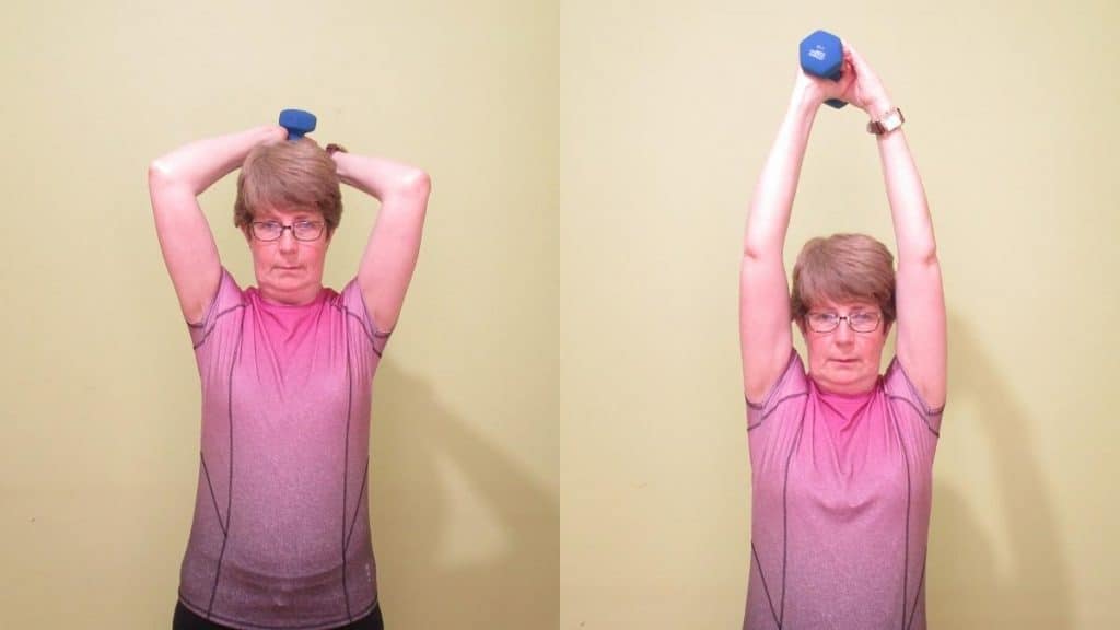 A lady doing an overhead extension for her triceps