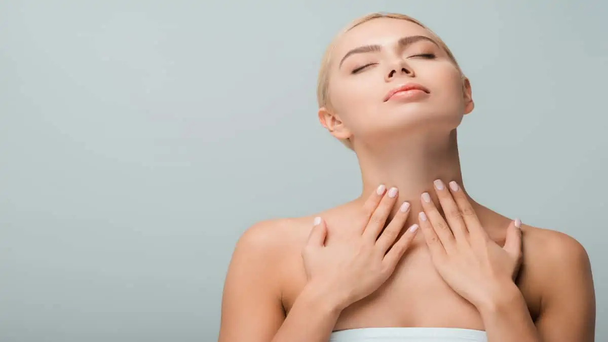 A young woman touching her 12 inch neck