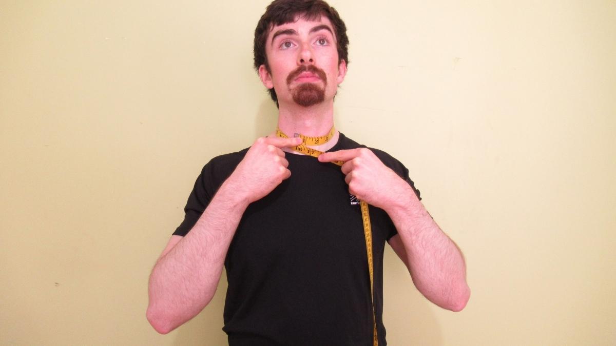 A man measuring his 15 inch neck