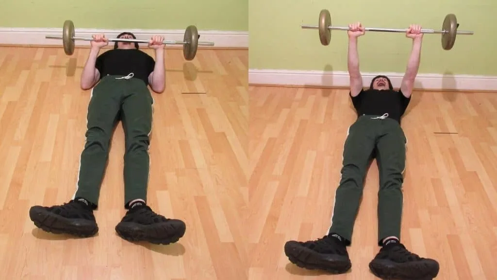 A man doing a barbell floor press