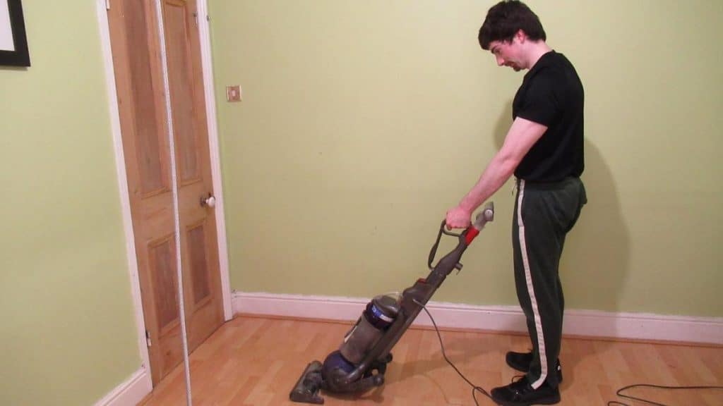 A man using a vacuum cleaner