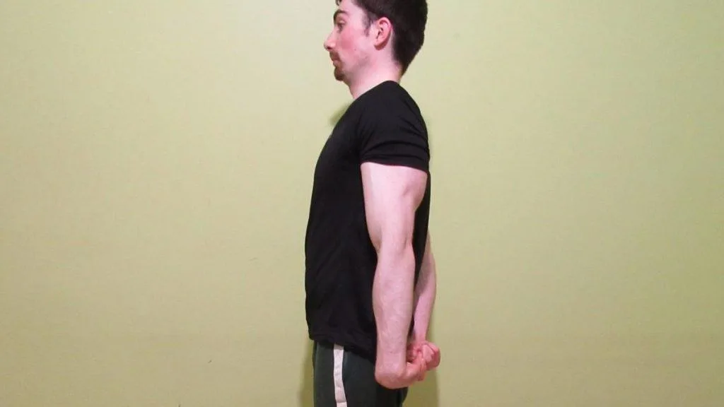 A muscular man flexing his triceps