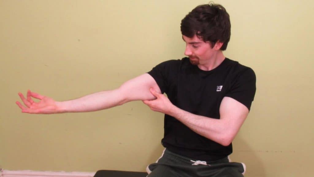 A man holding his weak tricep muscles