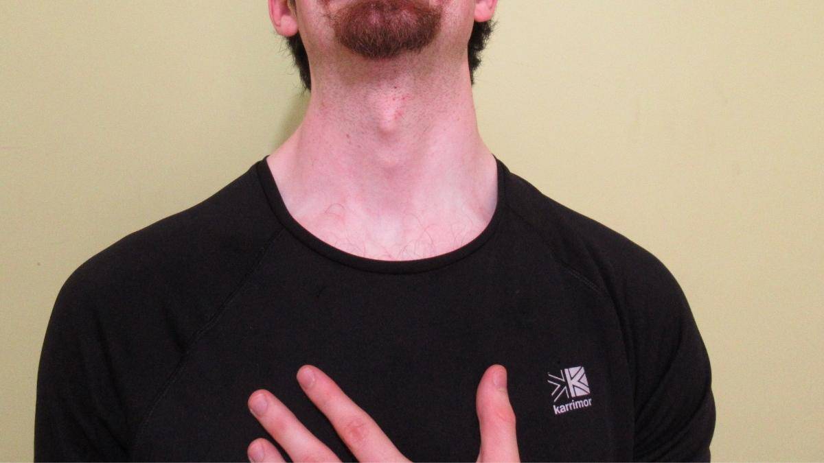 A man showing what a 15 inch neck looks like