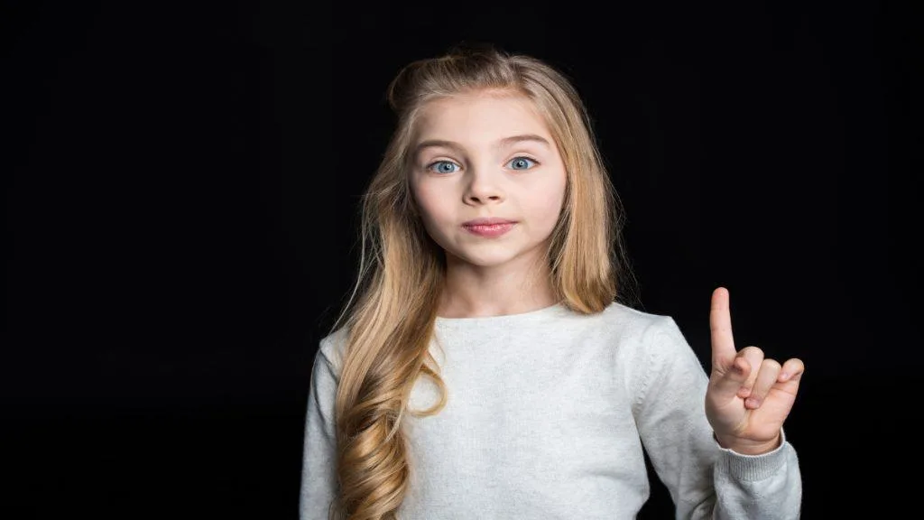 A young girl showing her finger