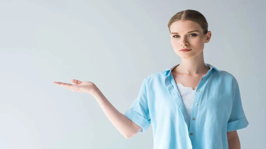 A young woman holding her hand out