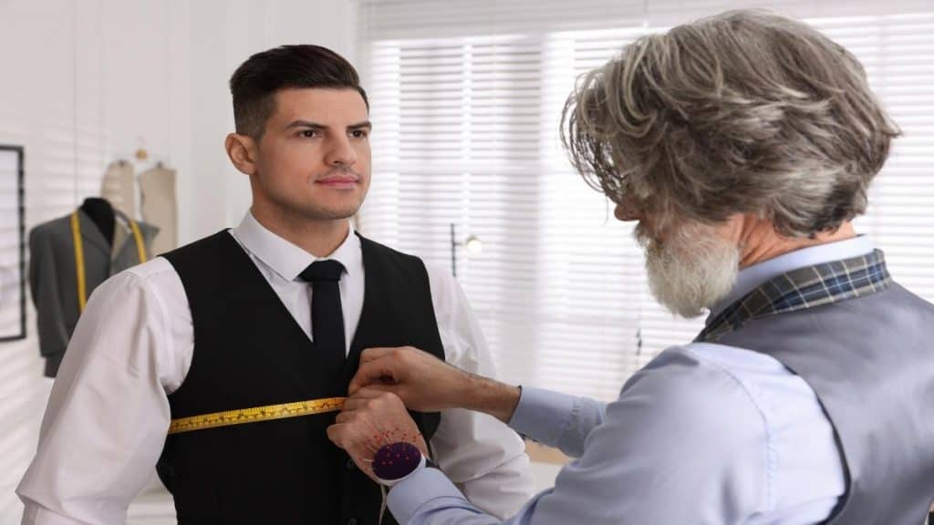 A man getting his 32 inch chest measured for a shirt