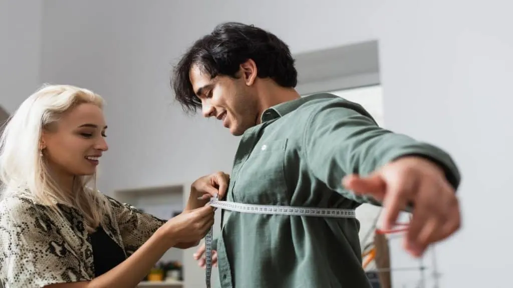 A man getting his 36 inch chest measured