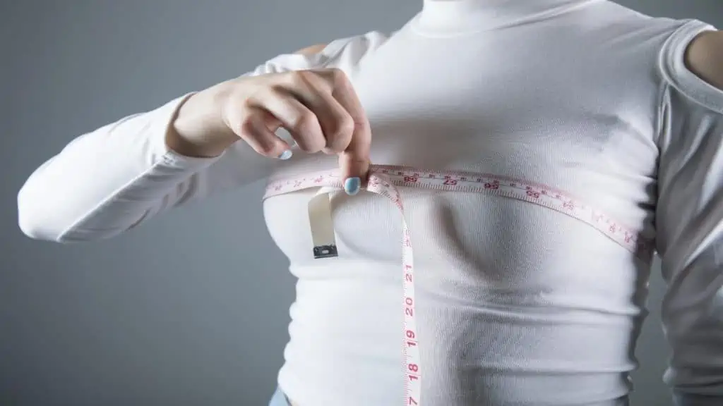 A woman measuring her 39 inch chest