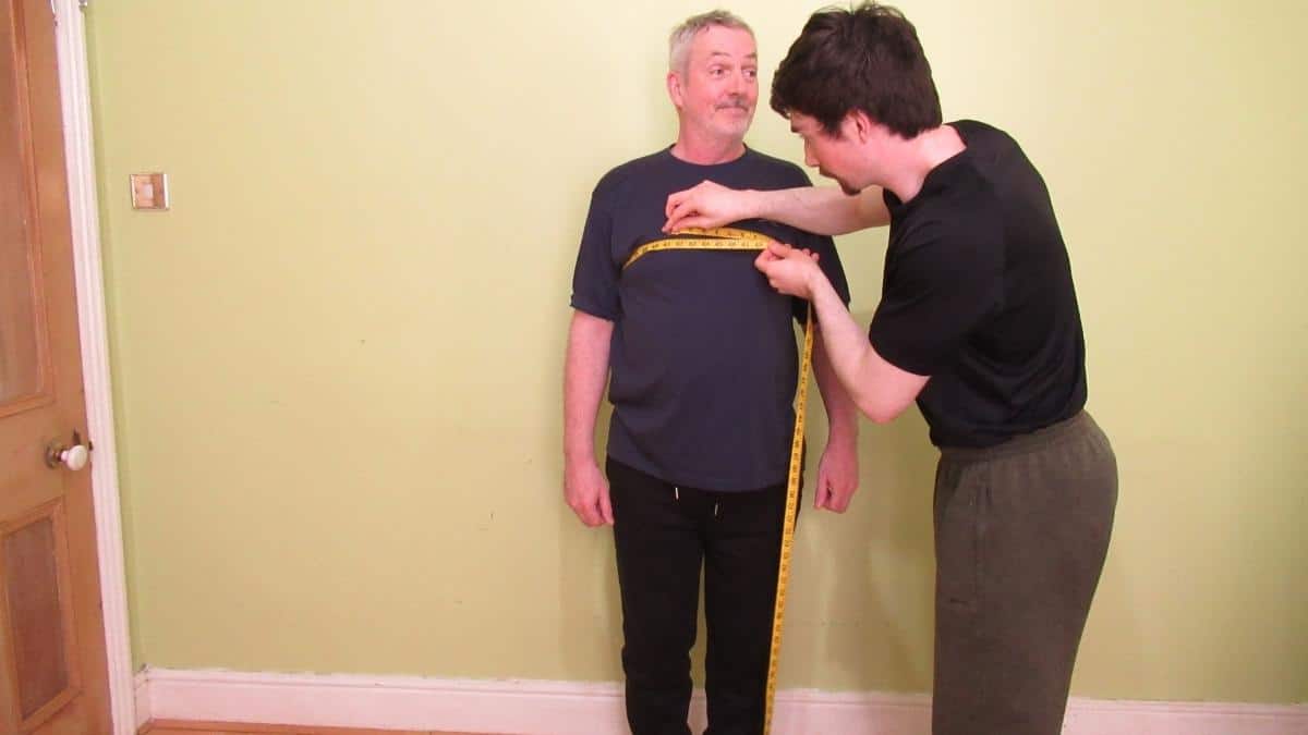 A man getting his 42 inch chest measured