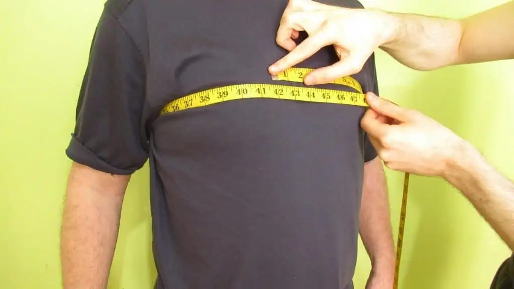 A man showing his 42 inch chest size