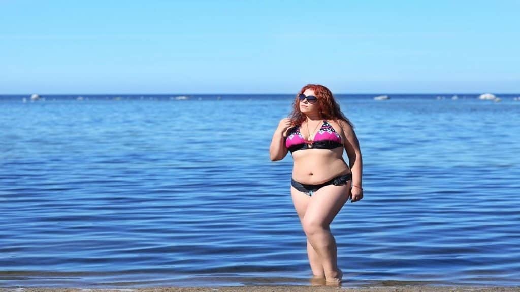 A woman with a 47 inch booty walking on the beach