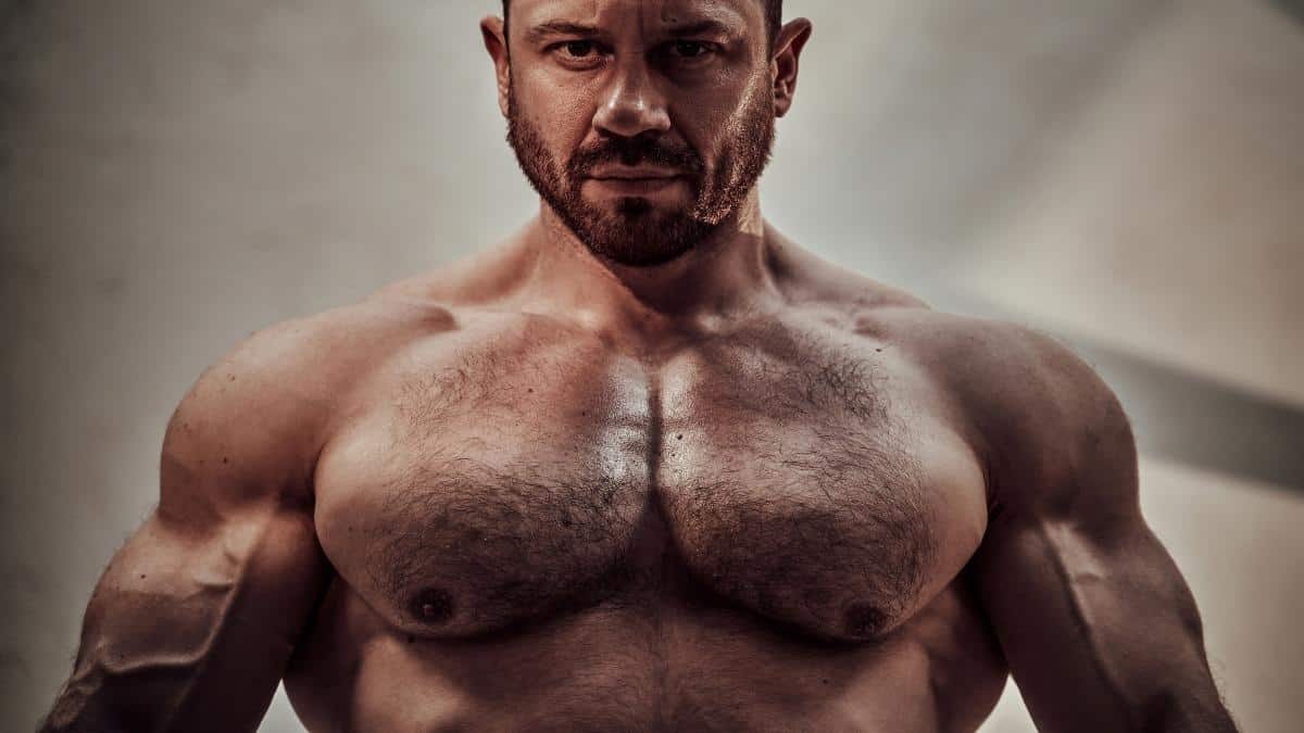 A bodybuilding man showing his big 50 inch chest