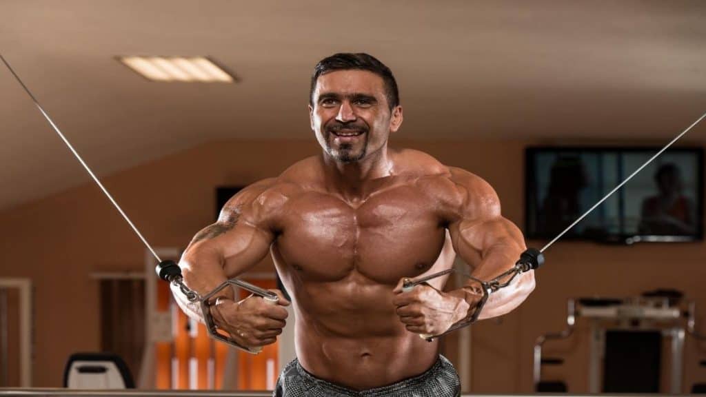 A bodybuilding man training his big 60 inch chest