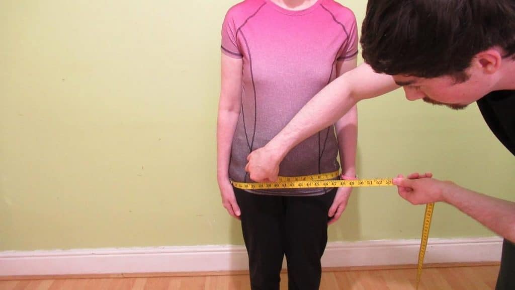 A woman showing that she has an average female hip circumference measurement