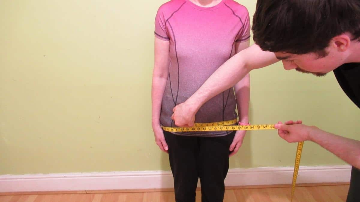 A woman showing that she has an average female hip circumference measurement