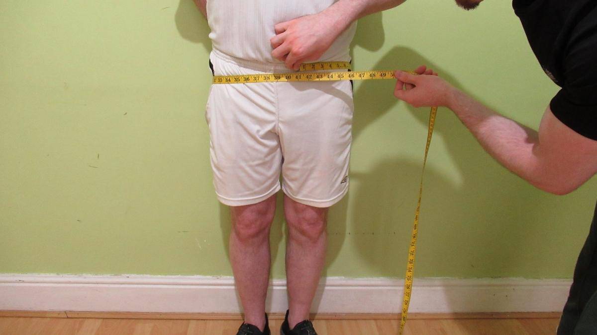 A male showing his very average hip circumference