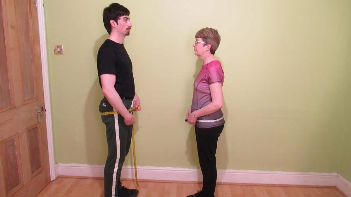 A man and a woman demonstrating the average hip size by height