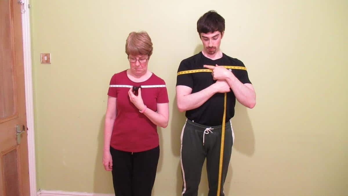 A man and a woman demonstrating the average shoulder width by height