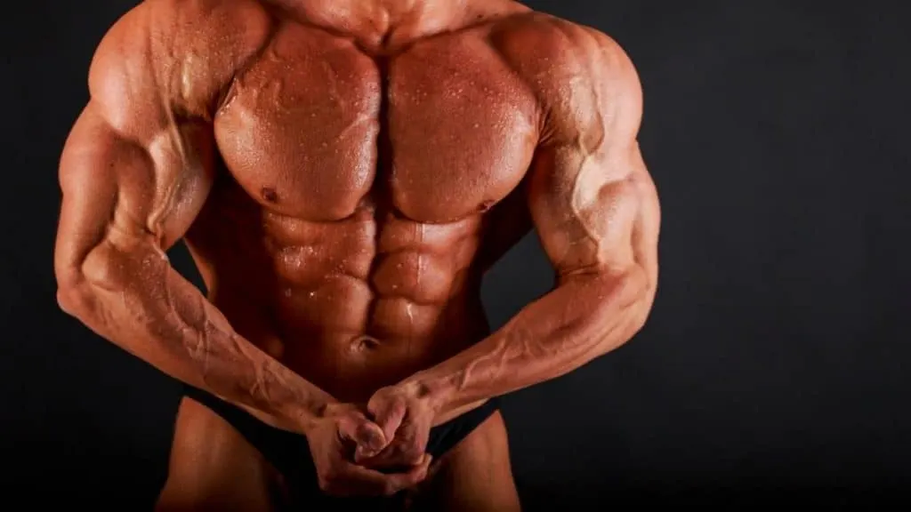 A strong bodybuilder showing that he has some of the biggest shoulders in the world