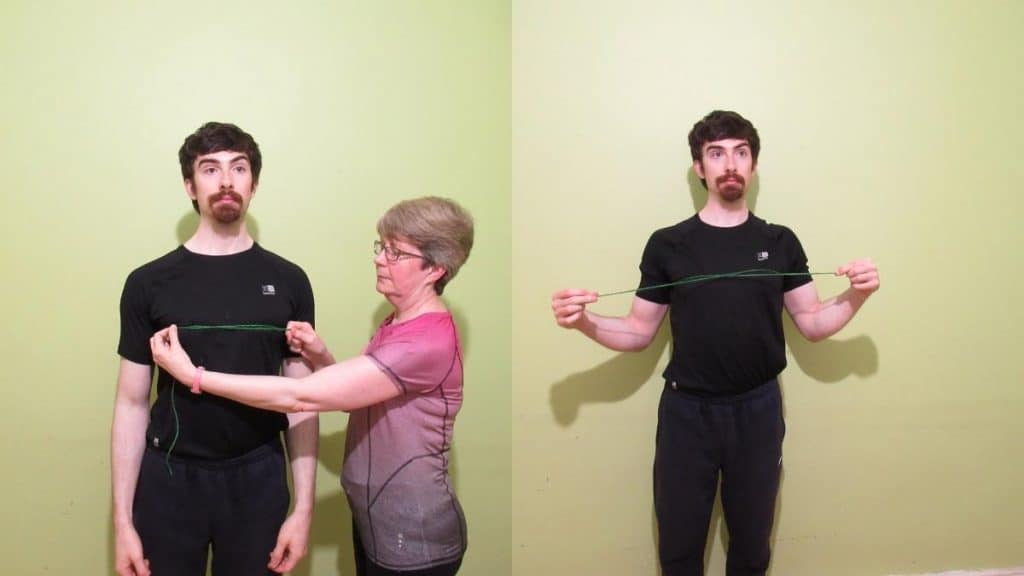 A man showing how to measure your chest size without a measuring tape