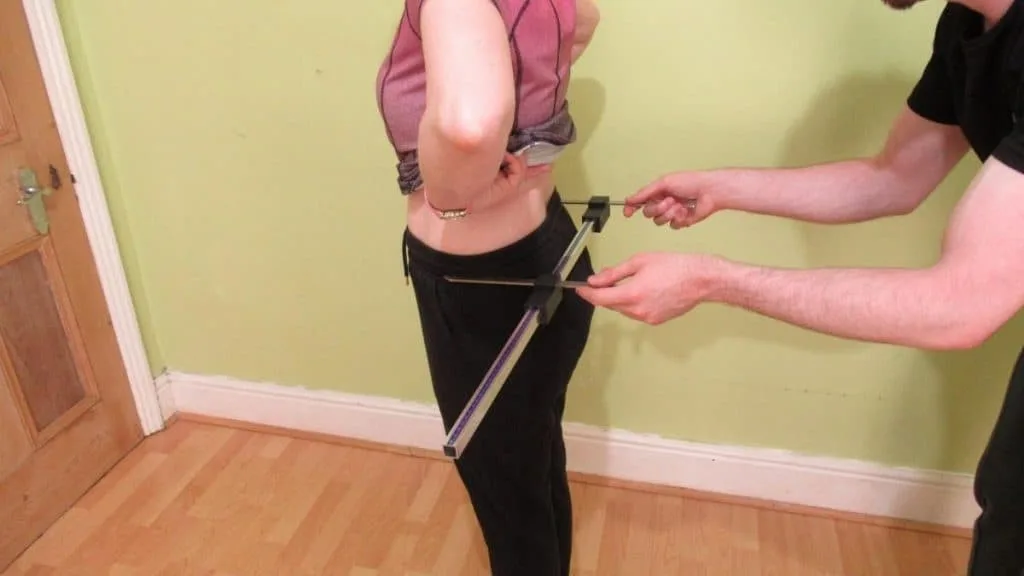 A man demonstrating how to measure hip width