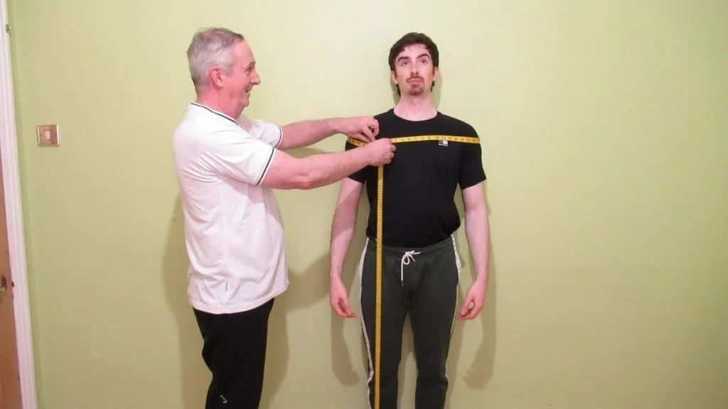 A man demonstrating how to measure your shoulder circumference